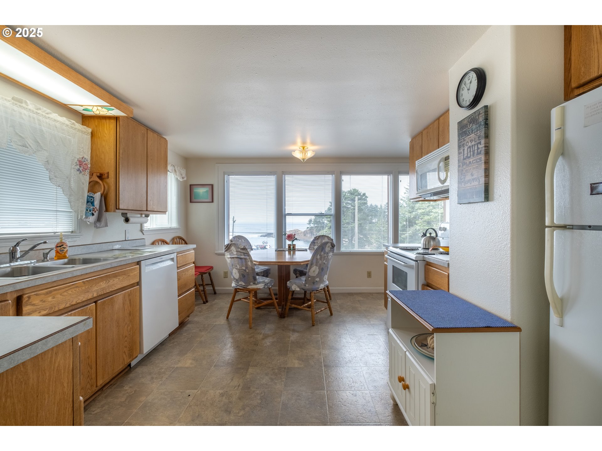 318 Highway 101 Depoe Bay, OR 97341 - Photo 14 of 47 a kitchen with furniture a refrigerator and a view of living room