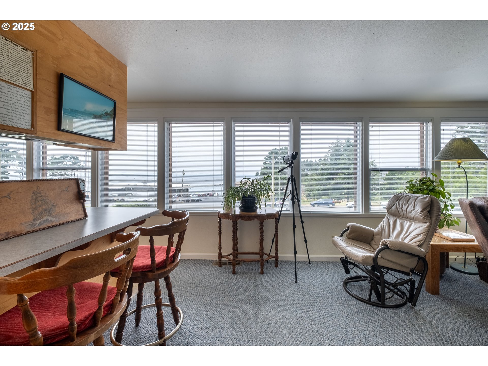 318 Highway 101 Depoe Bay, OR 97341 - Photo 17 of 47 a living room with furniture a flat screen tv and a large window