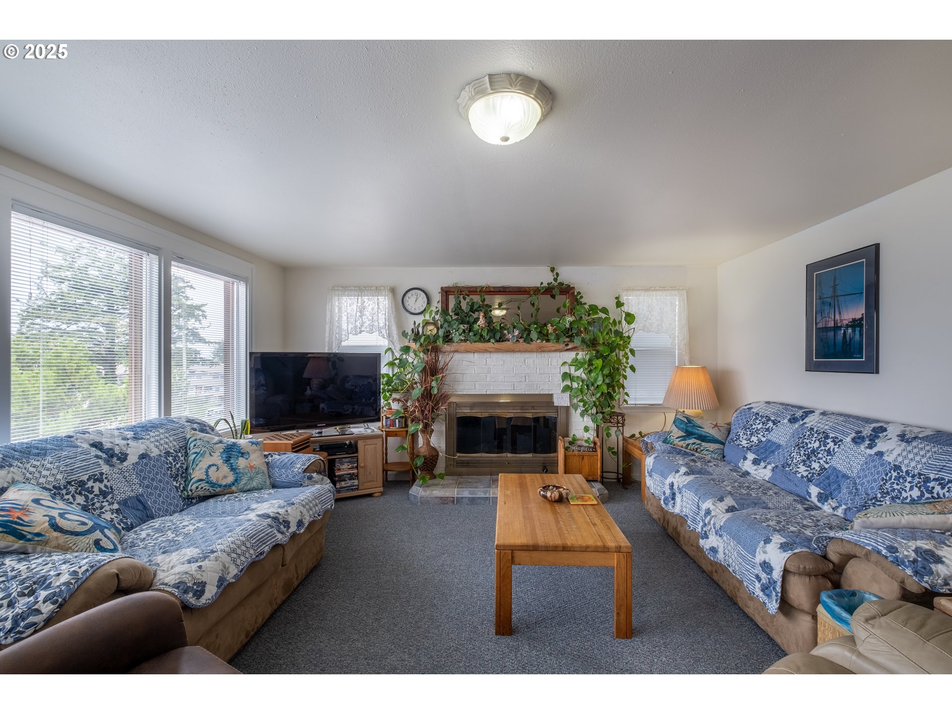 318 Highway 101 Depoe Bay, OR 97341 - Photo 21 of 47 a living room with furniture a fireplace and a flat screen tv