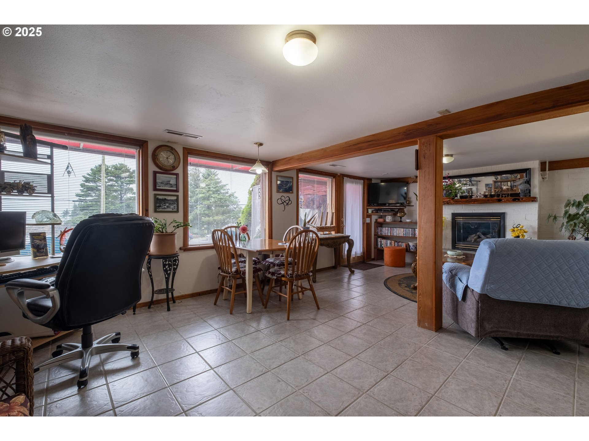 318 Highway 101 Depoe Bay, OR 97341 - Photo 31 of 47 a living room with furniture a large window and gym equipment