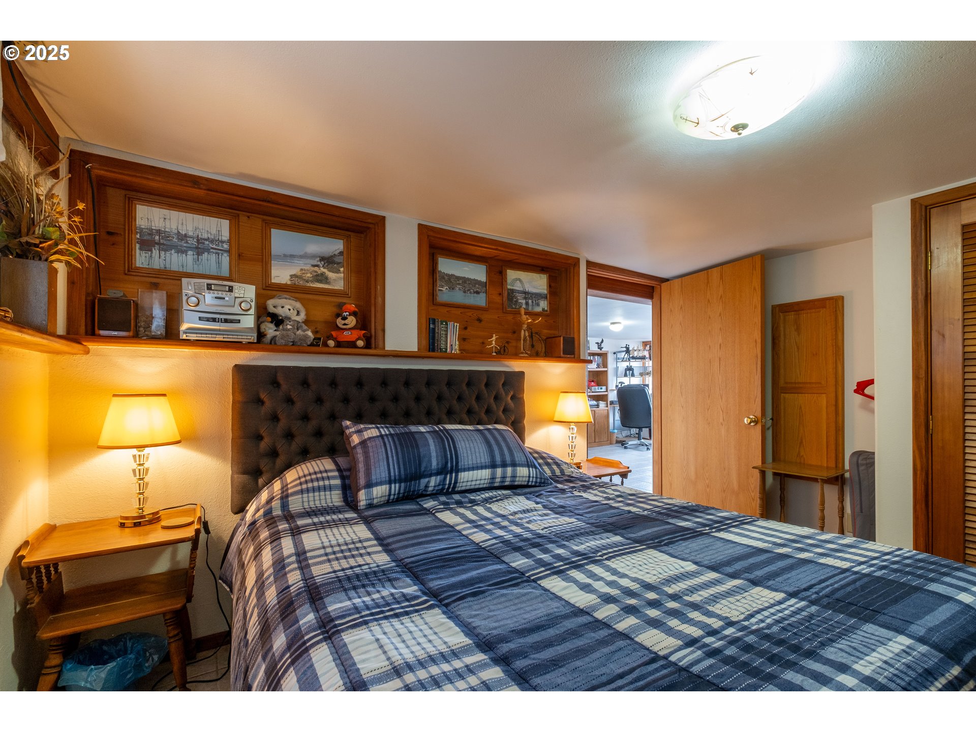 318 Highway 101 Depoe Bay, OR 97341 - Photo 43 of 47 a bedroom with a bed and wooden floor