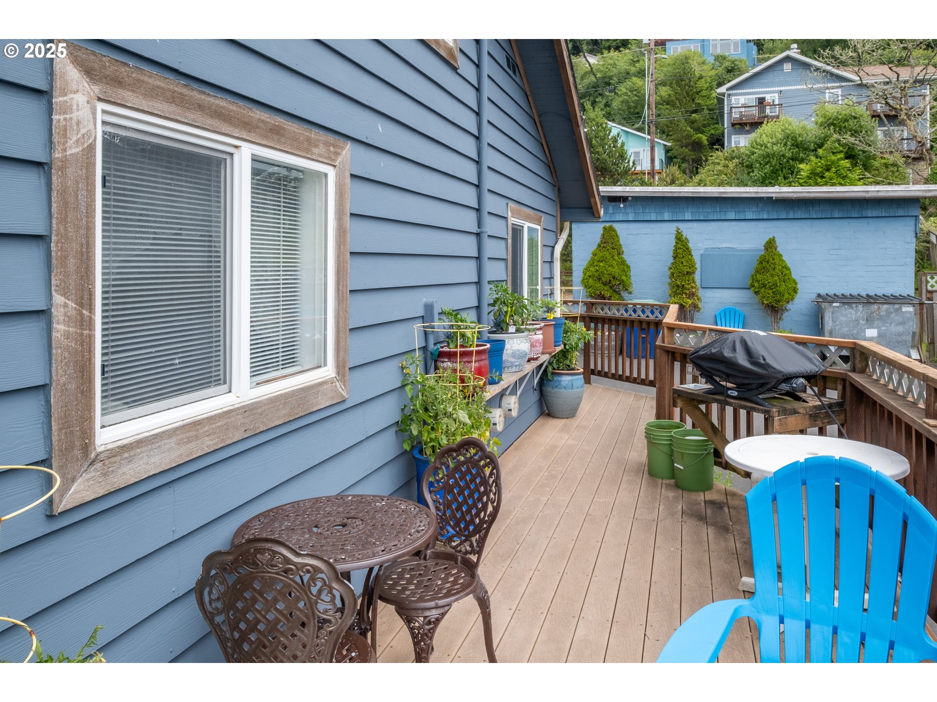 318 Highway 101 Depoe Bay, OR 97341 - Photo 9 of 47 a view of deck with table and chairs potted plants with wooden floor