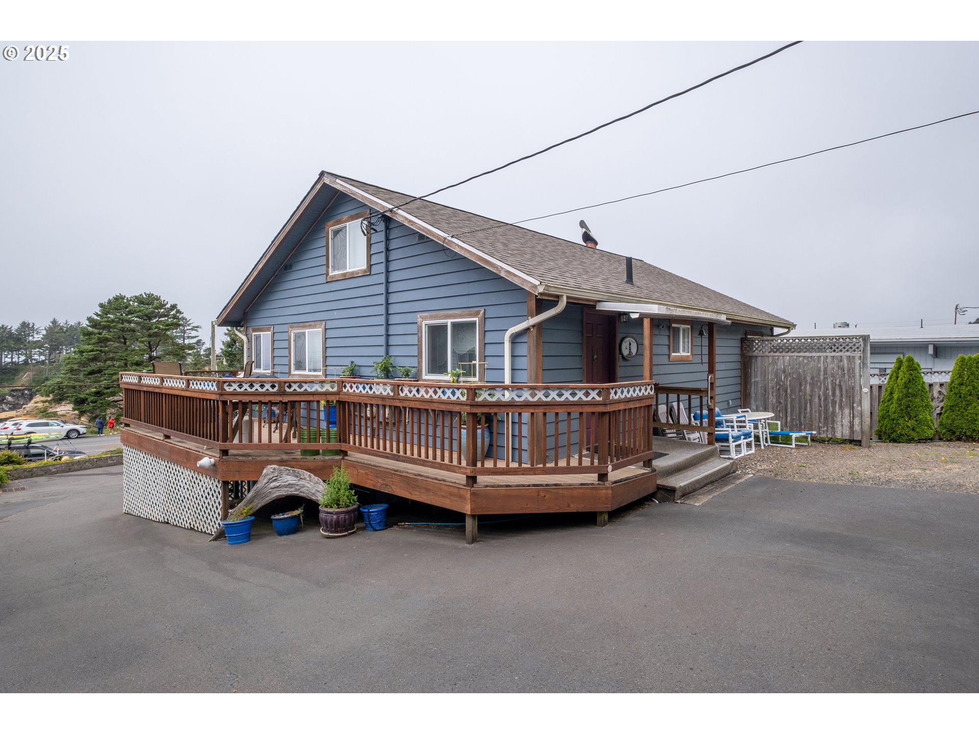 318 Highway 101 Depoe Bay, OR 97341 - Photo 10 of 47 a view of a house with a bed and wooden deck