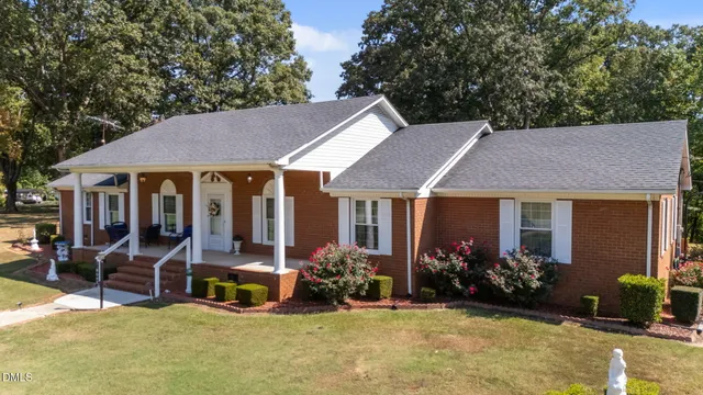 a view of a house with backyard porch and sitting area
