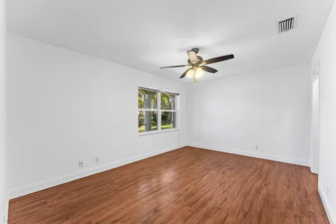 a view of a room with wooden floor and white walls