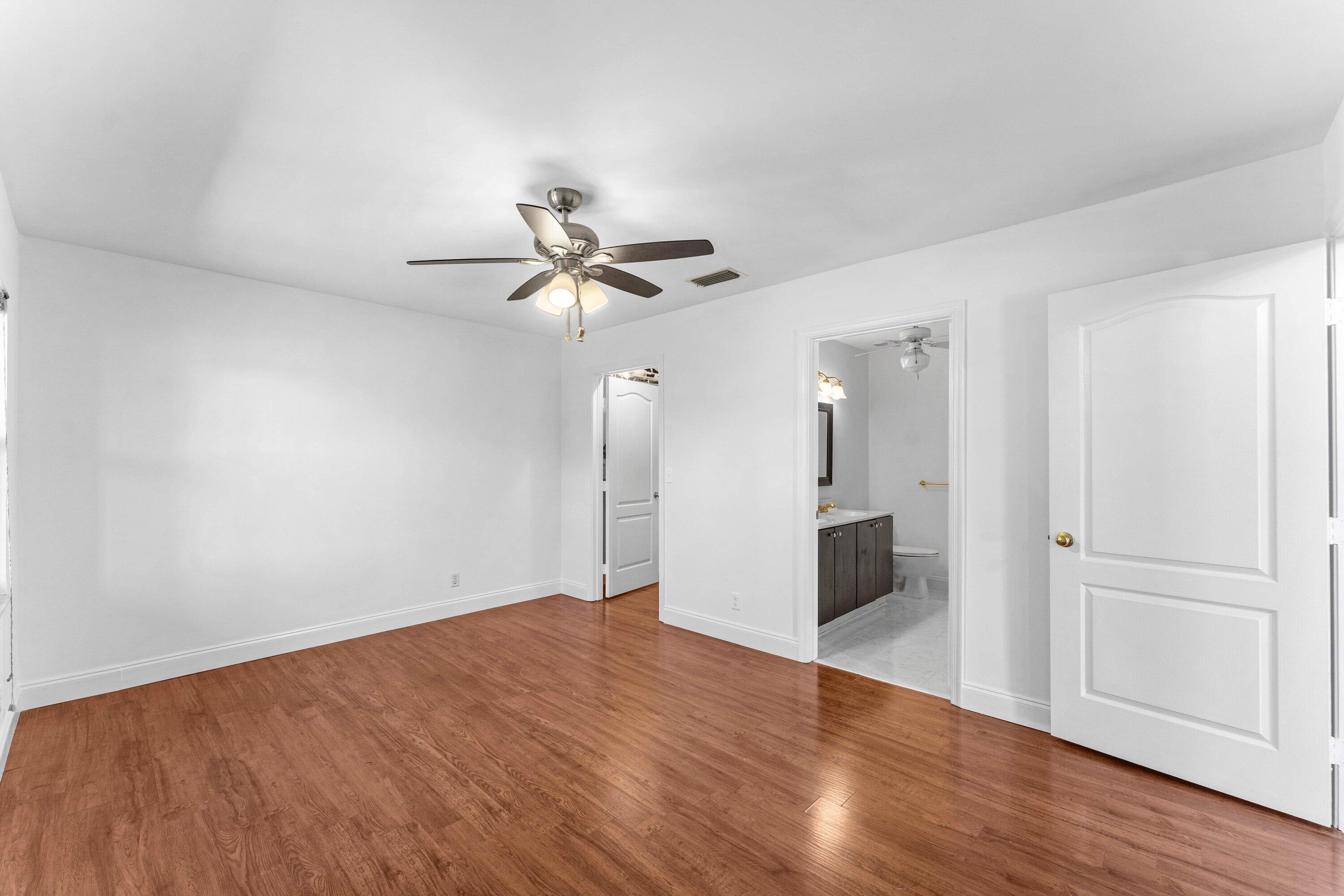 9118 Boca Gardens Parkway, Unit F Boca Raton, FL 33496 - Photo 31 of 56 a view of an empty room with wooden floor
