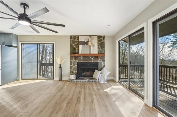 an empty room with fan and windows