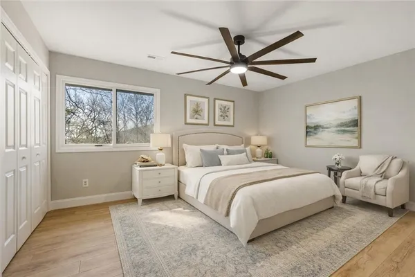 a bathroom with a granite countertop sink a toilet a mirror and shower