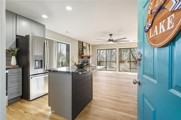 a kitchen with stainless steel appliances kitchen island granite countertop a refrigerator and a stove