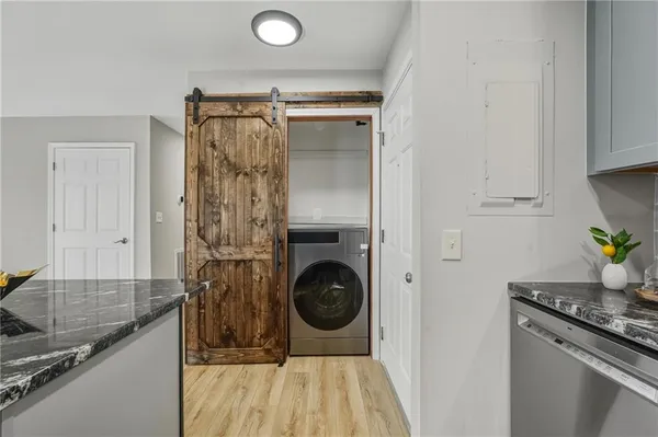 a kitchen with sink cabinets and stainless steel appliances