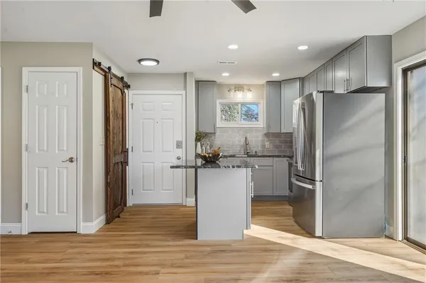 a kitchen with a refrigerator and a sink