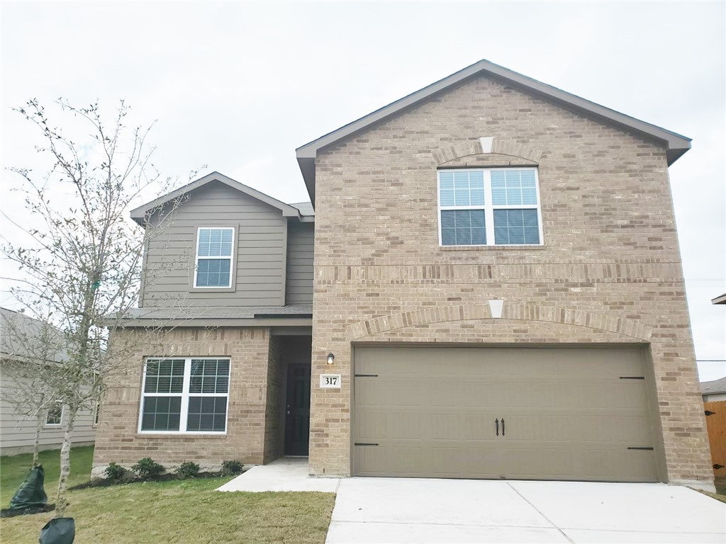 317 Hyacinth Way Jarrell, TX 76537 - Photo 1 of 21 a front view of a house with a yard