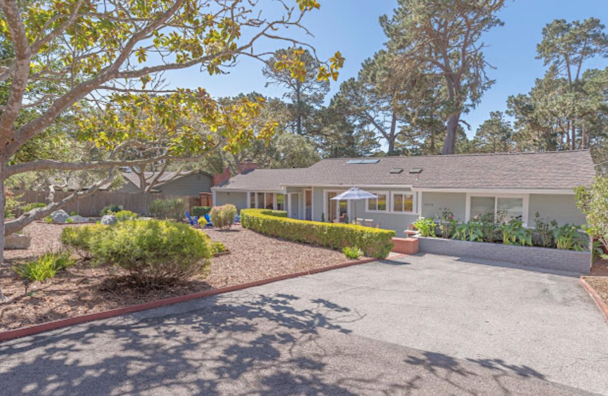 a front view of a house with a garden and a yard