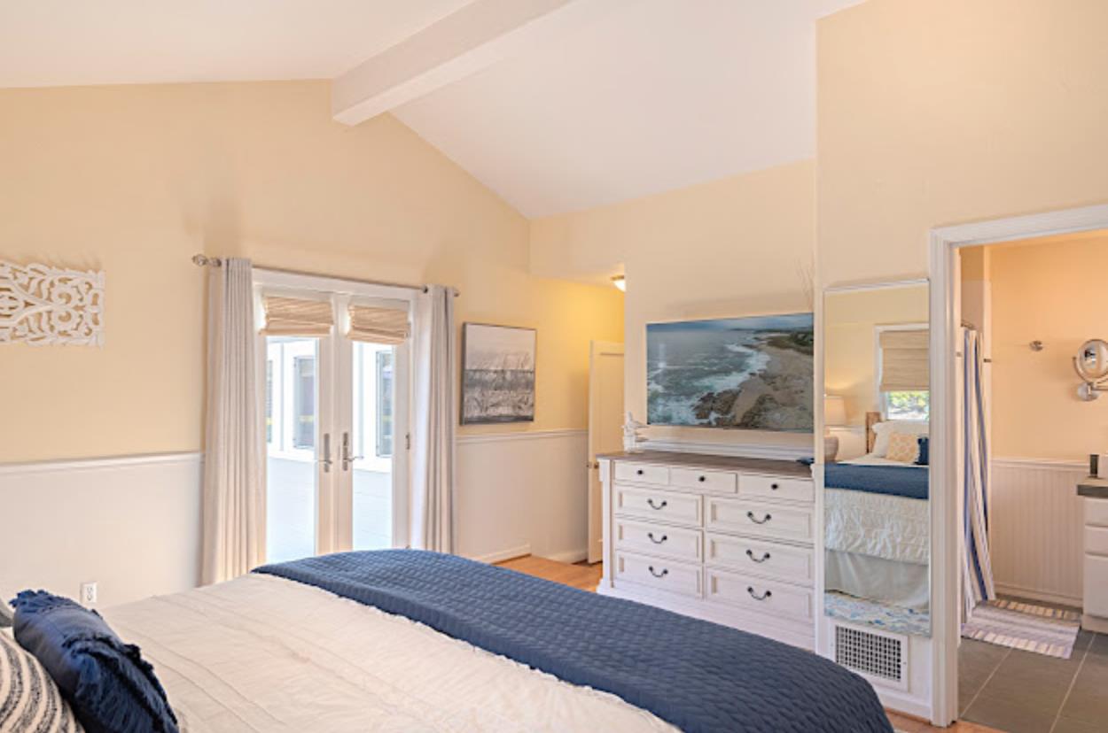 4174 Crest Road Pebble Beach, CA 93953 - Photo 9 of 14 a bedroom with a bed and wooden floor