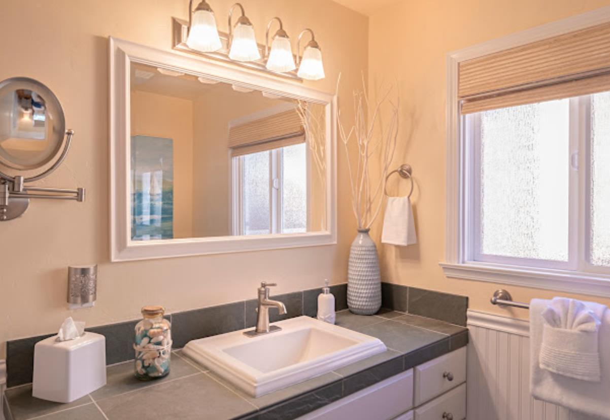 4174 Crest Road Pebble Beach, CA 93953 - Photo 10 of 14 a bathroom with a sink and a mirror