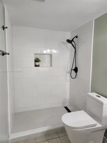 a white toilet sitting next to a bathroom sink