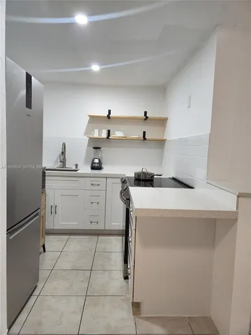 a kitchen with a stove cabinets and refrigerator