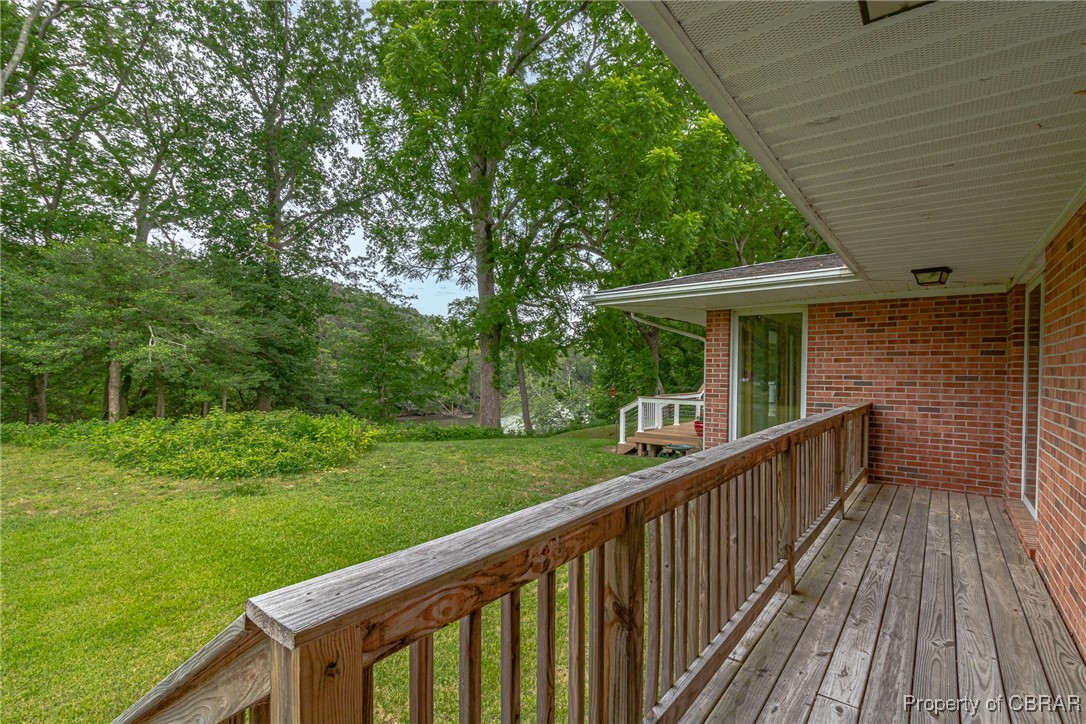 86 Greenfield Road Lancaster, VA 22503 - Photo 7 of 44 Deck with a lawn and view of wooded area
