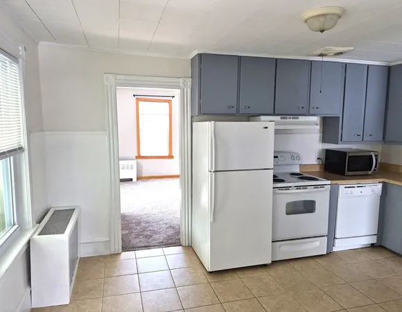 a white refrigerator freezer and a stove in a kitchen