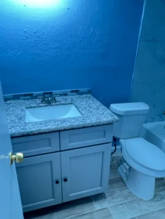 a bathroom with a toilet and a sink