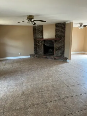 a view of empty room with fireplace