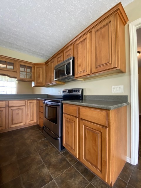 11426 East Radisson Road Mount Vernon, IL 62864 - Photo 8 of 56 a kitchen with stainless steel appliances granite countertop a stove a sink and a microwave