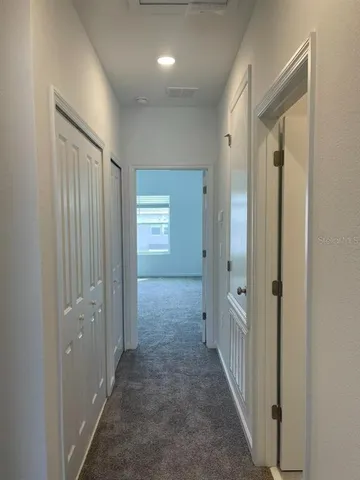 a view of a hallway with closet area