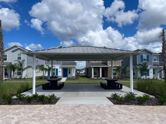 a view of a building with a yard in front of it