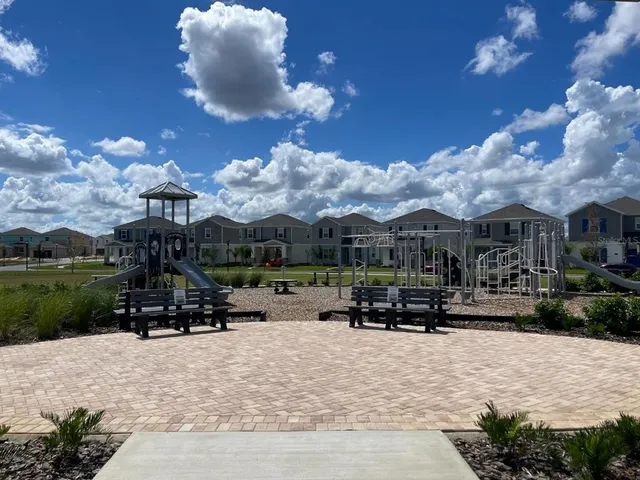 a sign broad in front of flowers