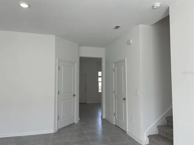 a view of a hallway with wooden shelves