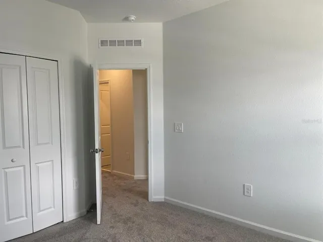 a view of a hallway with closet area