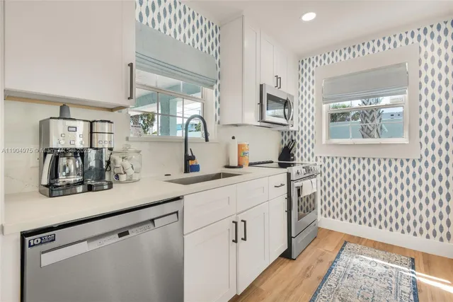 a kitchen with a sink cabinets and a window