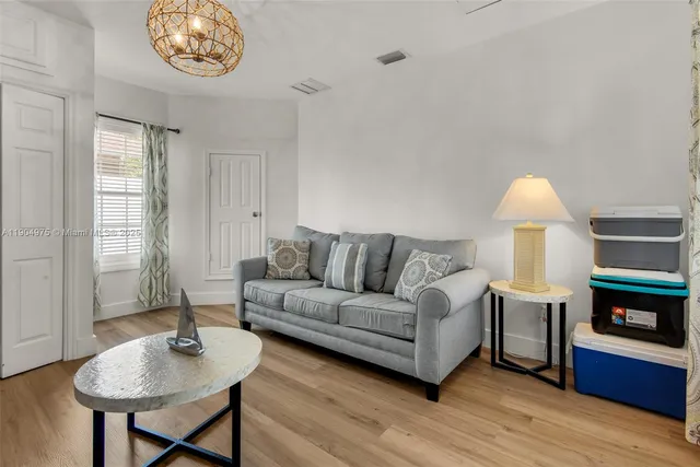 a living room with furniture a fireplace and a table