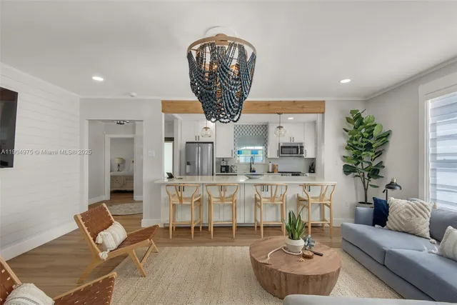 a living room with furniture a chandelier and a chandelier