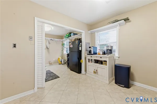 a kitchen with a refrigerator and a more cabinets