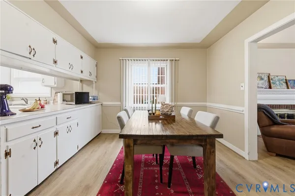 a large white kitchen with sink and window