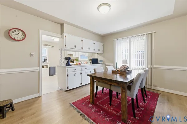 a kitchen with stainless steel appliances granite countertop a sink dishwasher a microwave oven a stove and a refrigerator with wooden floor