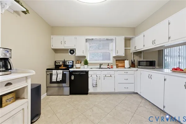 a kitchen with cabinets stainless steel appliances and sink