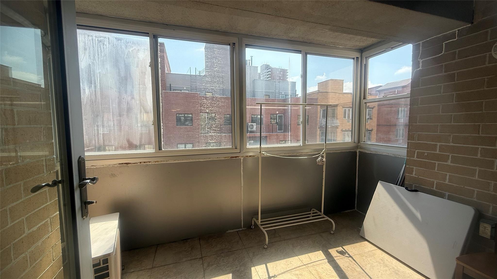 43-17 Union Street, Unit 6C Queens, NY 11355 - Photo 12 of 16 Unfurnished sunroom featuring plenty of natural light and a city view