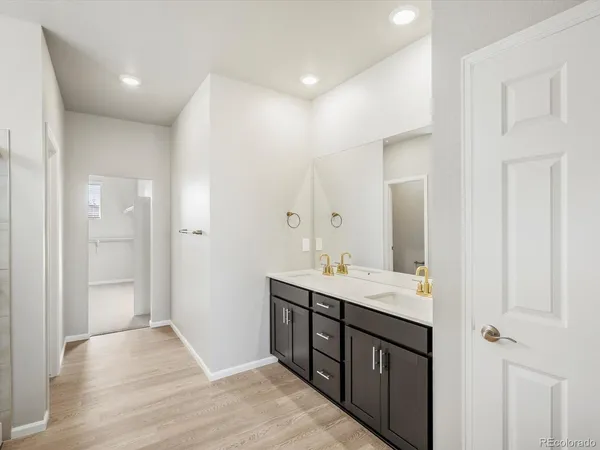 a bathroom with a double vanity sink and mirror
