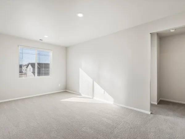 an empty room with a empty space and windows