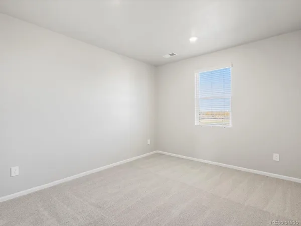 an empty room with a empty space and window