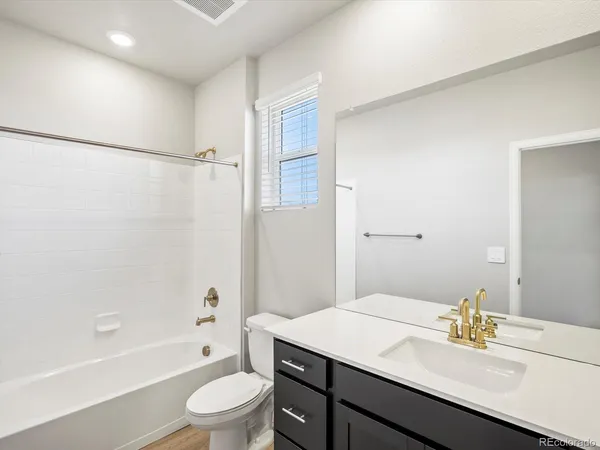 a bathroom with a sink a toilet and a bathtub