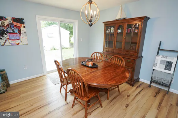 a view of a dining room with furniture wooden floor and chandelier