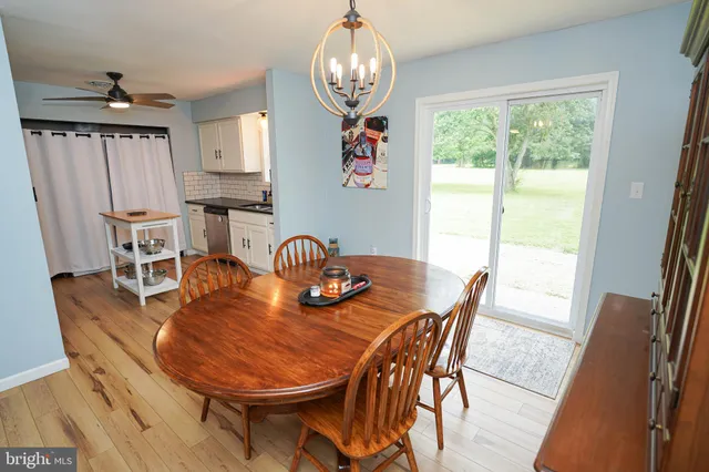 a kitchen with stainless steel appliances granite countertop a stove a sink dishwasher and cabinets with wooden floor