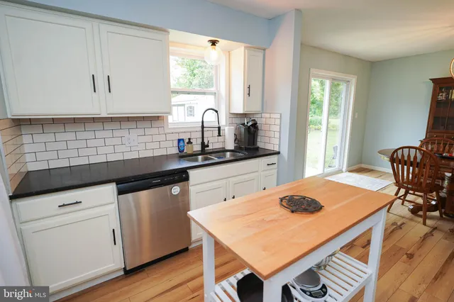 a view of a bedroom with wooden floor