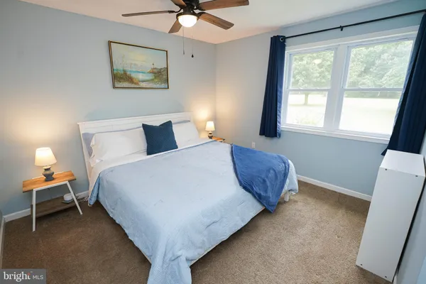 a view of a bedroom with wooden floor and closet