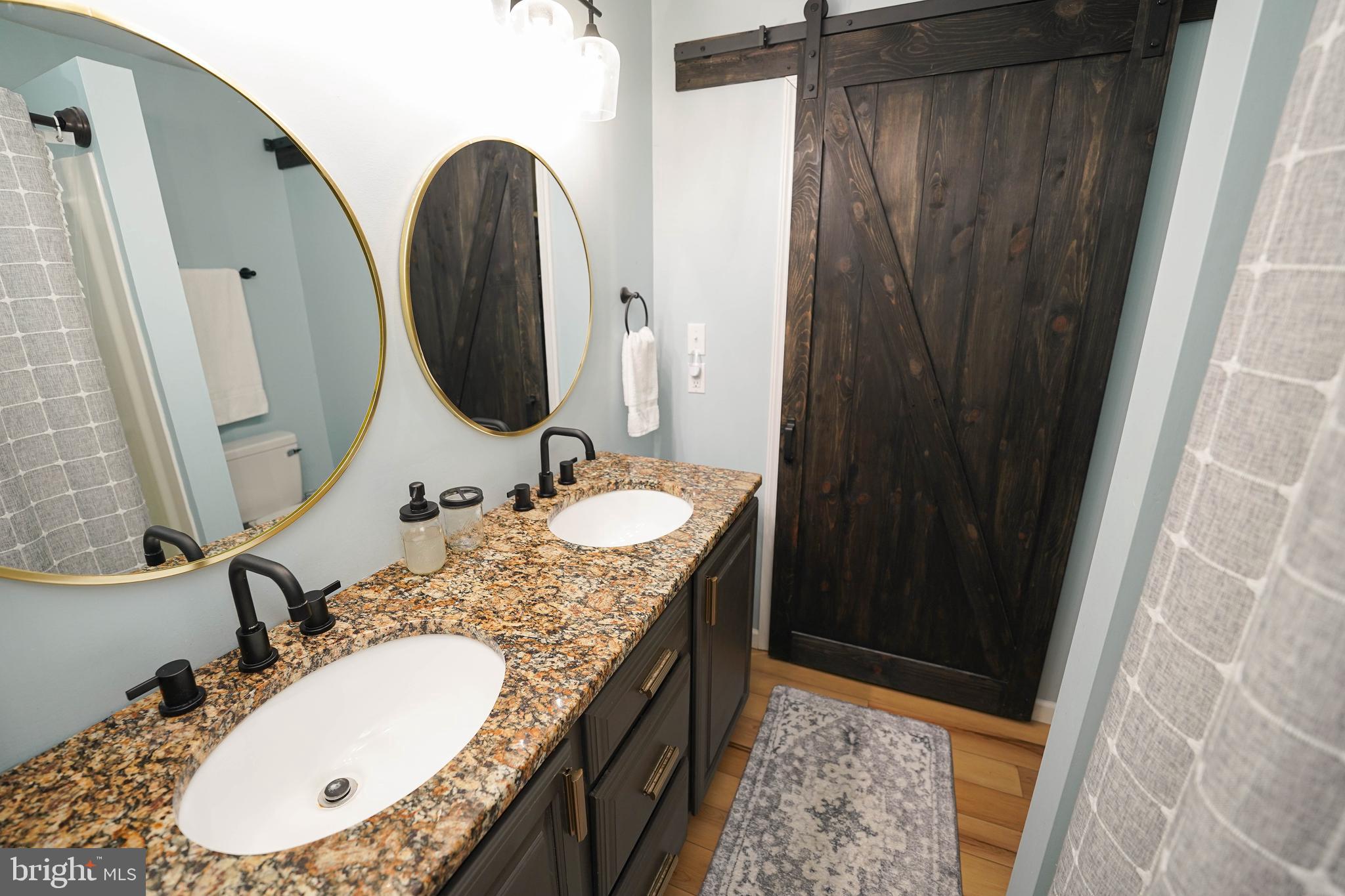 7209 Opal Circle Hebron, MD 21830 - Photo 31 of 41 a bathroom with a granite countertop sink and a mirror