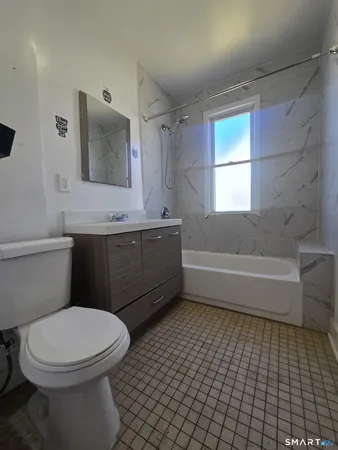 a bathroom with a toilet a sink and bathtub