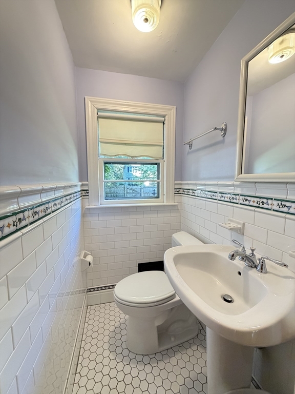 115 Parker Road Wellesley, MA 02482 - Photo 12 of 22 a bathroom with a sink toilet and a mirror